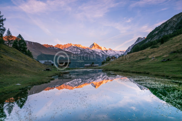 Red Mountain Tops Reflecting in Alpine Lake - Switzerland